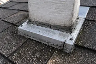 Cracked Roof Sealant Repair | Sun Haven Roofing Cracked sealant around a roof penetration that may lead to leaks if not properly repaired.
