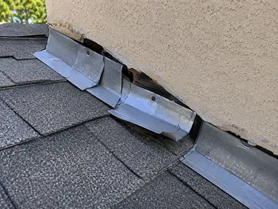 Damaged Roof Flashing Repair | Sun Haven Roofing Bent and damaged roof flashing around a wall connection that can allow water to enter the home.