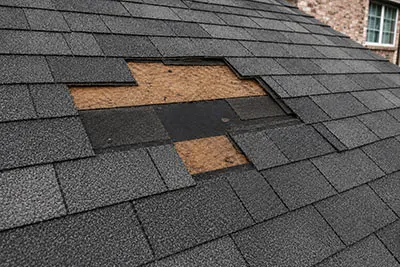 Missing Roof Shingles Repair | Sun Haven Roofing Missing asphalt shingles exposing the roof deck, increasing the risk of leaks and water damage.